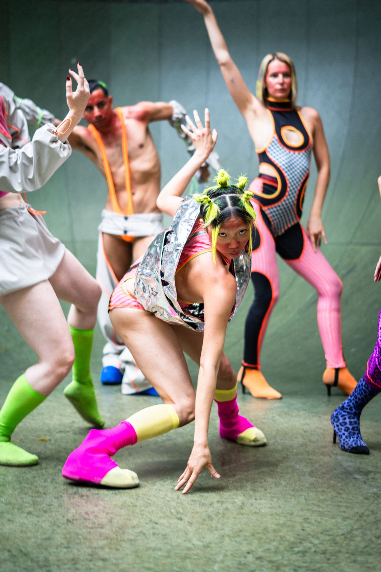 Performers in vivid sportswear caught mid-movement
