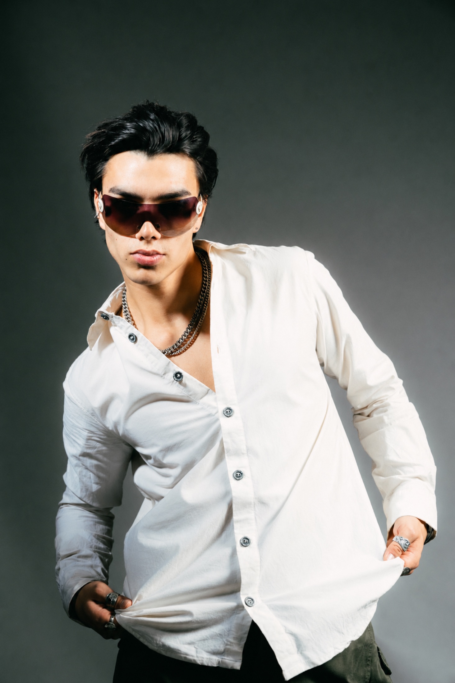Studio portrait in white shirt and dark sunglasses